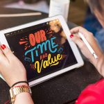 woman holding silver ipad
